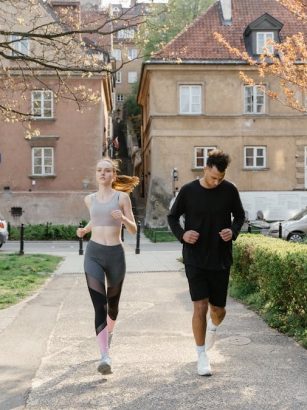 A couple jogging together in an urban park, enjoying outdoor exercise.
