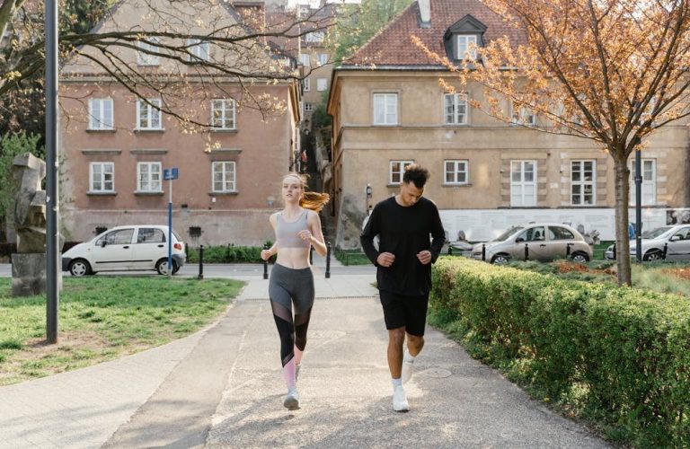 A couple jogging together in an urban park, enjoying outdoor exercise.