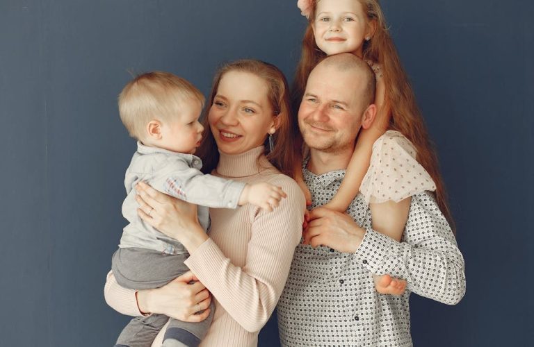 A joyful family portrait showcasing parents and their two children, expressing love and togetherness.